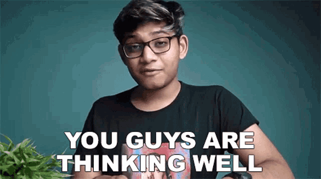 a young man wearing glasses is standing in front of a plant and says `` you guys are thinking well '' .