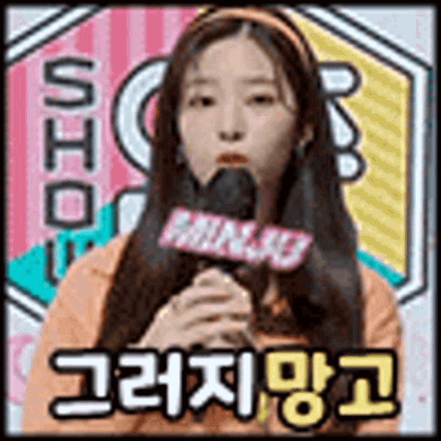 a girl is holding a microphone in her mouth and talking into it .