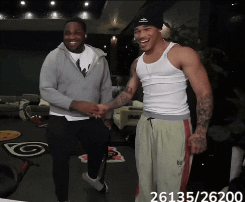 two men shaking hands with the number 26135/26200 behind them