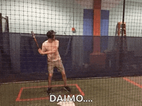 a man is swinging a bat at a ball and the word daimo is on the bottom of the screen