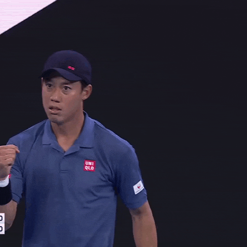 a man wearing a blue shirt that says uniqlo on the sleeve