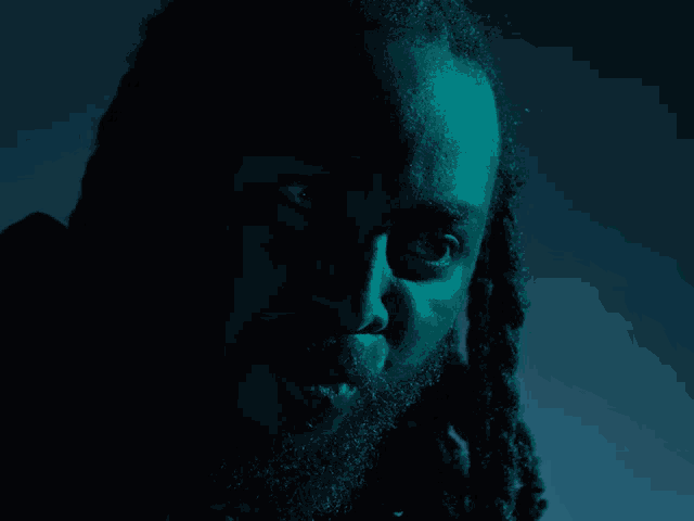 a man with dreadlocks and a beard says what in yellow