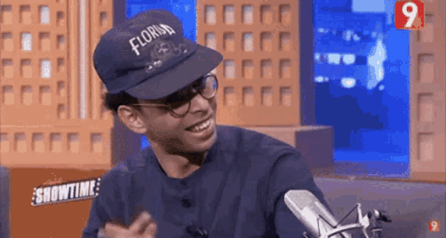 a man wearing a hat that says florida on it is smiling