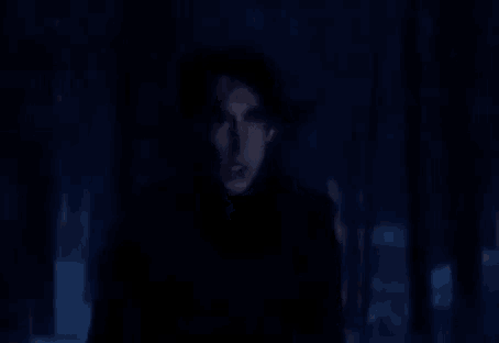 a man is screaming in the dark and the word traidor is on the screen behind him
