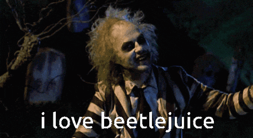 a man in a striped shirt and tie says " i love beetlejuice "