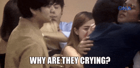 a group of people are hugging each other with the caption " why are they crying "