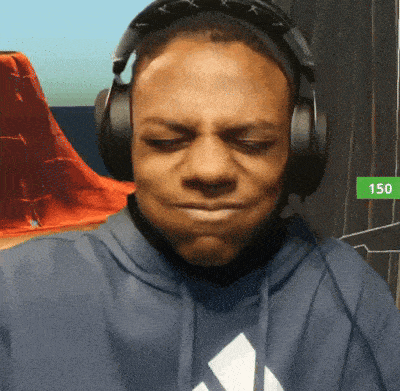 a man wearing headphones and a blue hoodie with the number 150 on the bottom