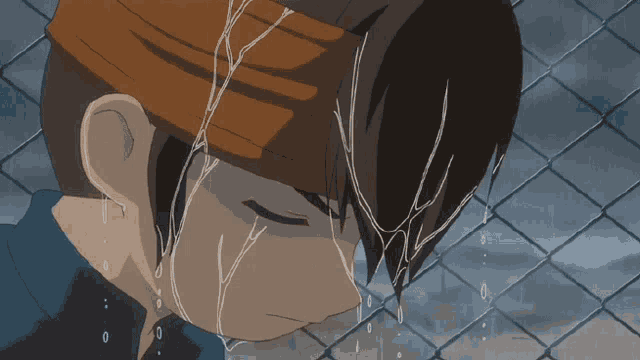 a man with a headband on his head is crying