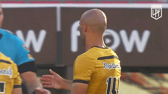 a soccer player wearing a yellow jersey with the number 11 on it