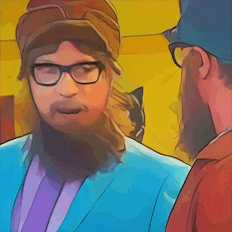 a man with a beard wearing glasses and a hat talks to another man