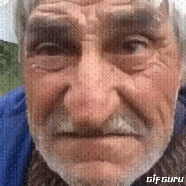 a close up of a man 's face with the words gif guru on the bottom left