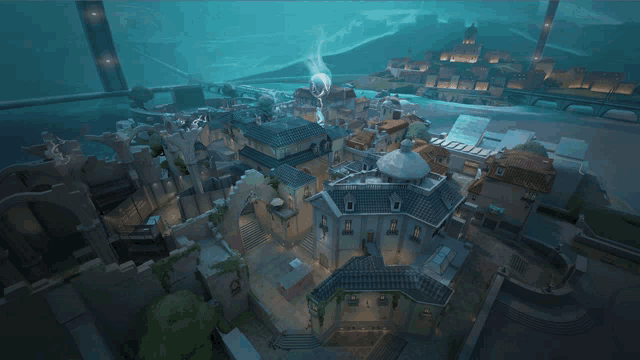 an aerial view of a city with buildings and a bridge in the background