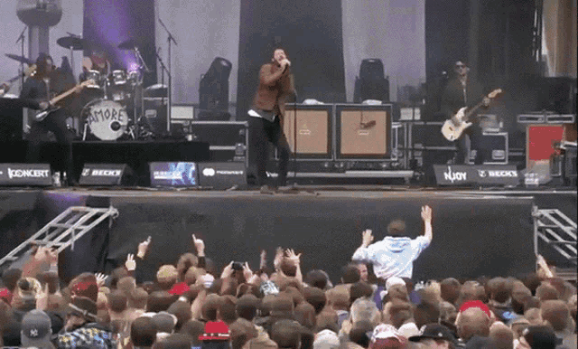 a band on stage with a drum that says smoke