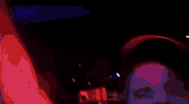 a man wearing a hat is screaming in a crowd at a concert .