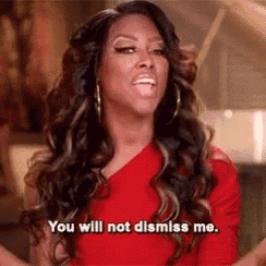 a woman in a red dress is talking and says `` you will not dismiss me . ''