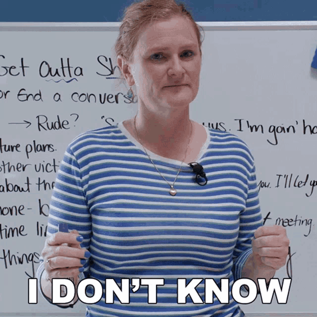 a woman standing in front of a white board with the words " i don 't know "