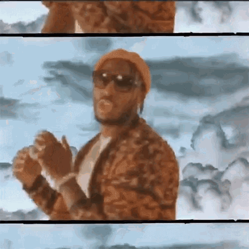 a man wearing sunglasses and a beanie stands in front of a cloudy sky .