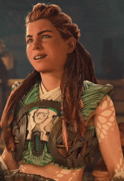 a close up of a woman wearing a green top with a r on it