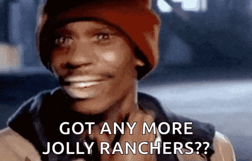a man in a red beanie is smiling and asking if he has any more jolly ranchers .