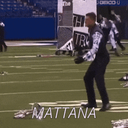 a man is dancing on a football field with the name mattana written on the ground