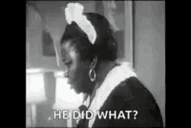 a black and white photo of a woman in a maid costume talking to a man .