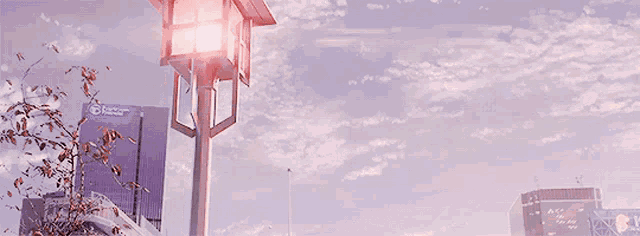 a street light is lit up in front of a building that says lcc