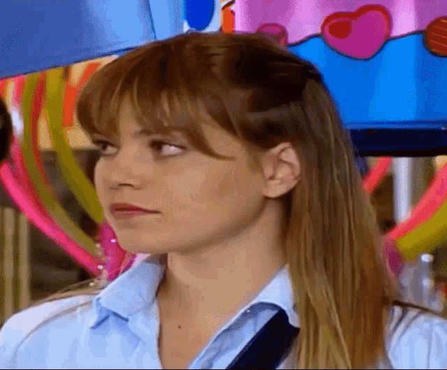 a close up of a woman 's face in front of a colorful background