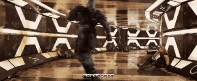 a man in a military uniform is running through a hallway with a sign that says ' x '