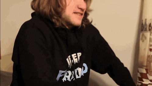 a man wearing a hoodie that says sleep frid