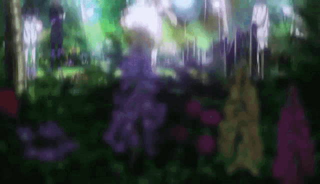 a blurry picture of a forest with purple flowers in the foreground