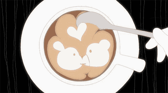 a spoon is being used to stir a cup of coffee with a drawing of two birds on it