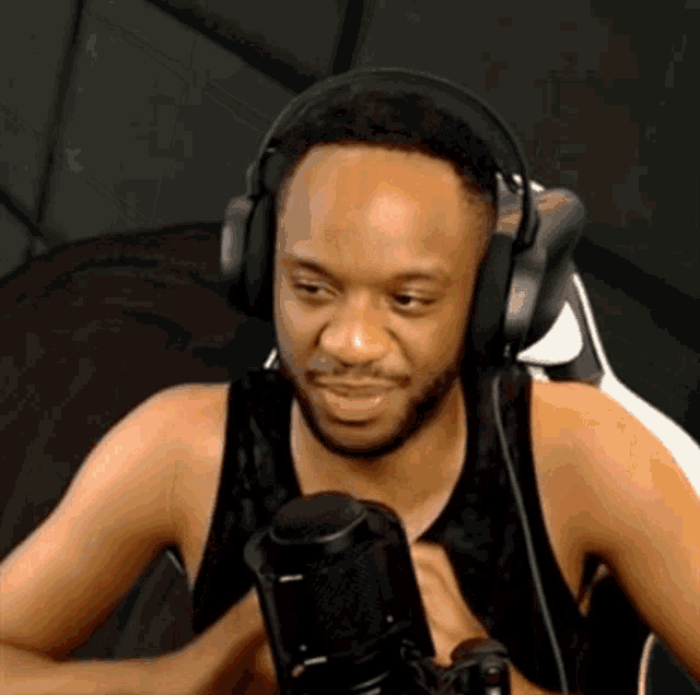 a man wearing headphones is talking into a microphone