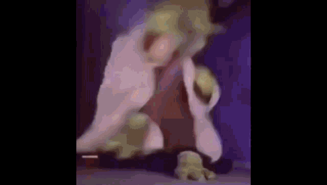 a blurred image of a person with a purple and blue glow