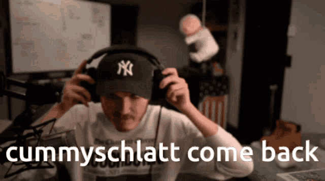 a man wearing headphones and a ny hat says " cummyschllatt come back "