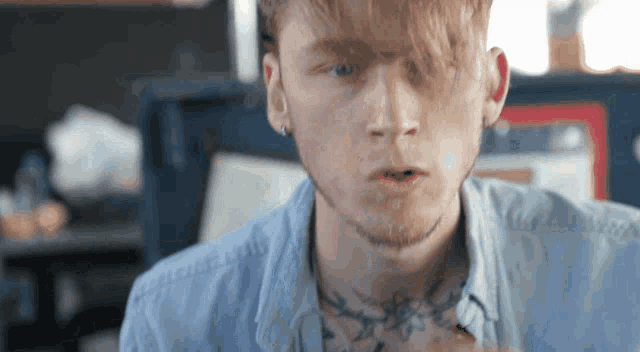 a close up of a man 's face with a tattoo on his neck