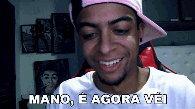 a man wearing a pink hat says mano e agora vei