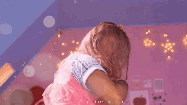 a girl with pink hair is wearing a tiara and a blue shirt with the name cornstarch on the bottom