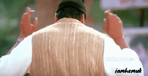 a man 's back is shown in a video that says iamhemuk on the bottom