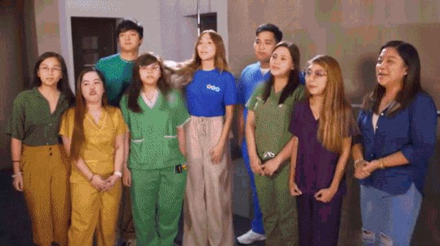 a group of people standing next to each other wearing scrubs and a t-shirt that says coo