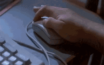 a person is using a white computer mouse on a keyboard