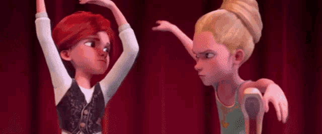 a boy and a girl are standing next to each other on a stage in front of a red curtain .
