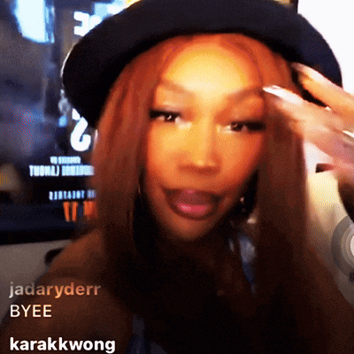 a woman wearing a black hat has the name jadaryderr byee written on her face