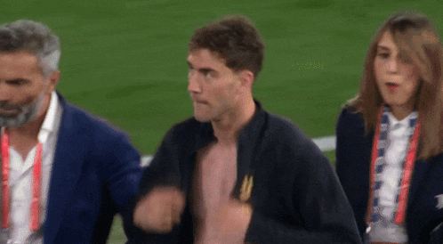 a man without a shirt is walking on a field