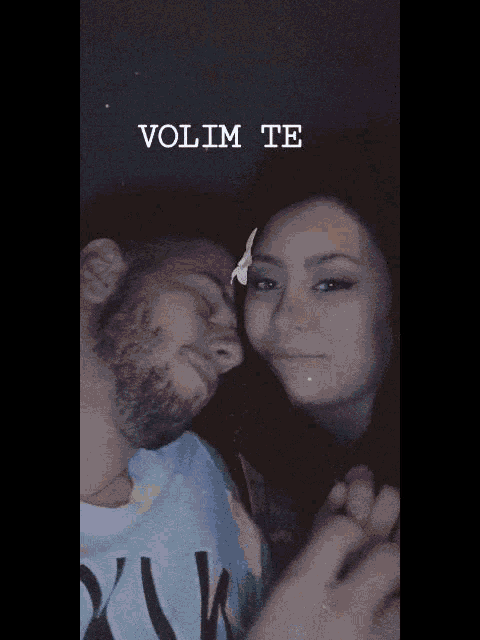 a man and a woman are holding hands with the words volim te behind them