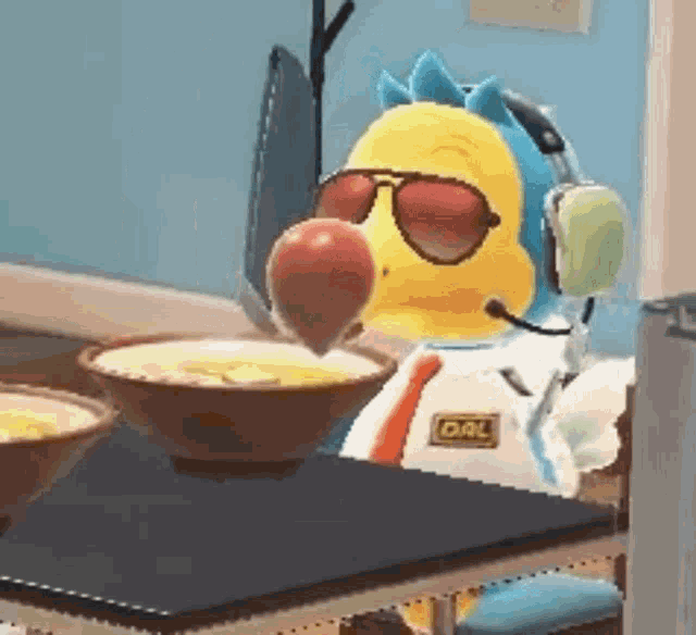 a stuffed animal wearing sunglasses and headphones is sitting at a table eating an apple .
