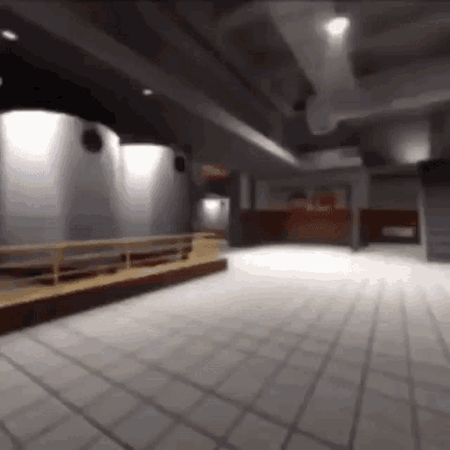 a blurry picture of a large empty room with a staircase leading up to the ceiling .