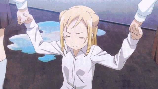 a girl in a white shirt is holding someone 's hand and making a funny face
