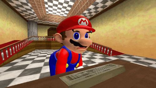 a video game character named mario is sitting at a desk