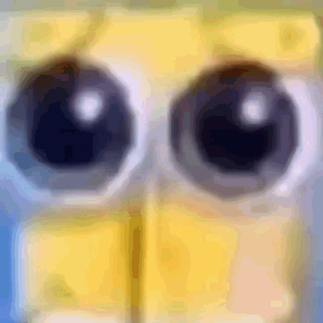 a close up of a cartoon character 's eyes with a blurred background