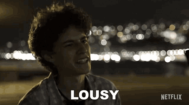 a young man says lousy in front of a blurred background
